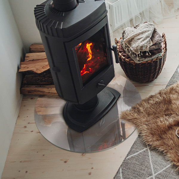 Plaque de sol ronde en verre cheminée motif organique en pierre