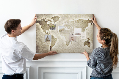 Tableau de liège Une carte du monde à l'ancienne en arrière-plan.