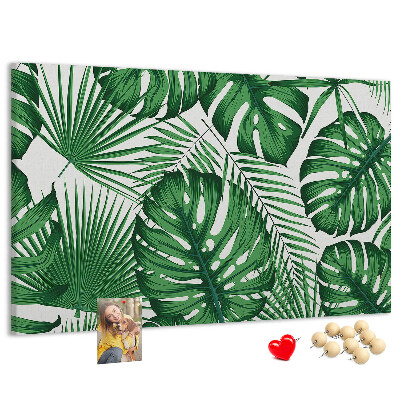 Tableau en liège De nombreuses feuilles de plantes tropicales en vert