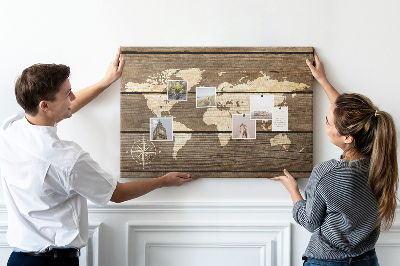 Tableau en liège Une carte du monde sur un fond de planches de bois