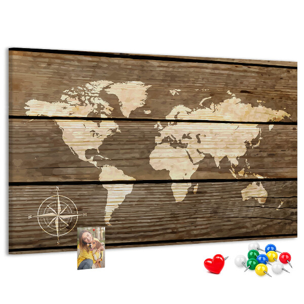 Tableau en liège Une carte du monde sur un fond de planches de bois