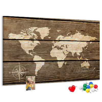 Tableau en liège Une carte du monde sur un fond de planches de bois