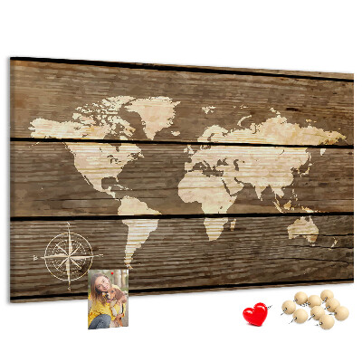 Tableau en liège Une carte du monde sur un fond de planches de bois
