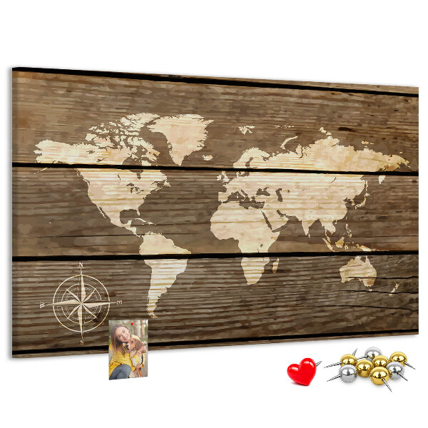 Tableau en liège Une carte du monde sur un fond de planches de bois
