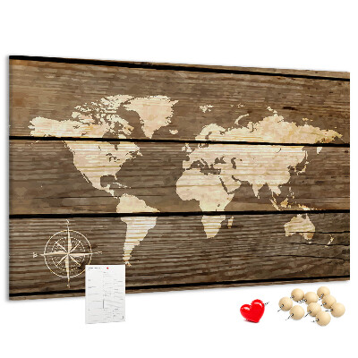Tableau en liège Une carte du monde sur un fond de planches de bois