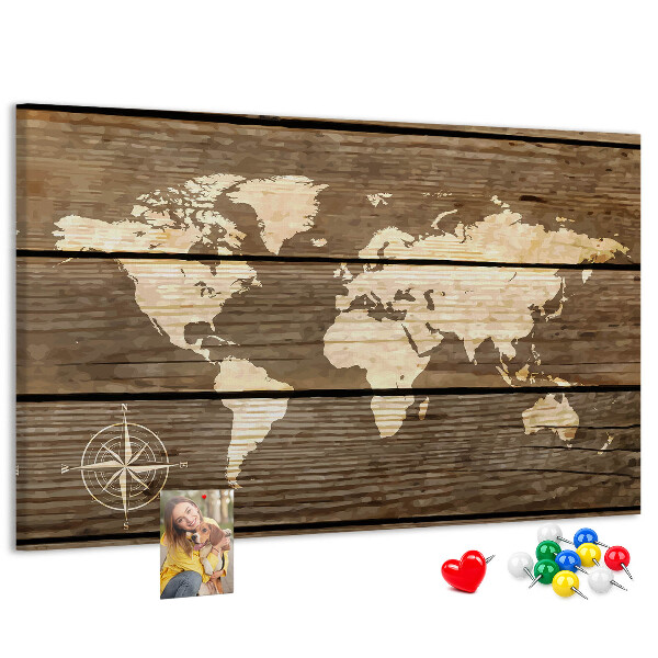 Tableau en liège Une carte du monde sur un fond de planches de bois