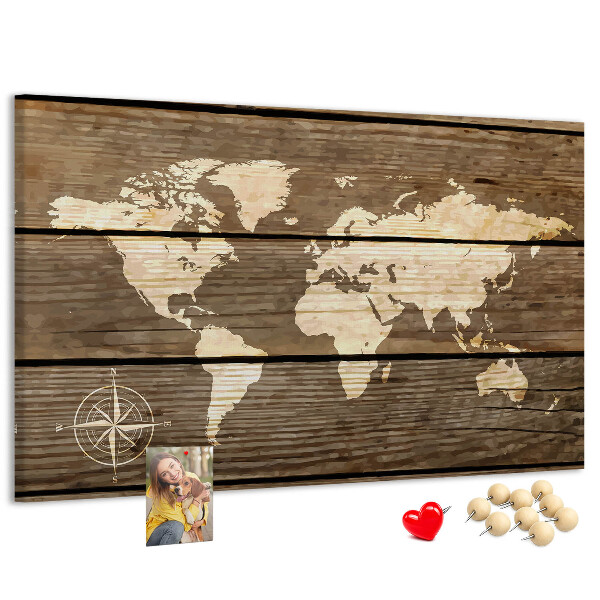 Tableau en liège Une carte du monde sur un fond de planches de bois