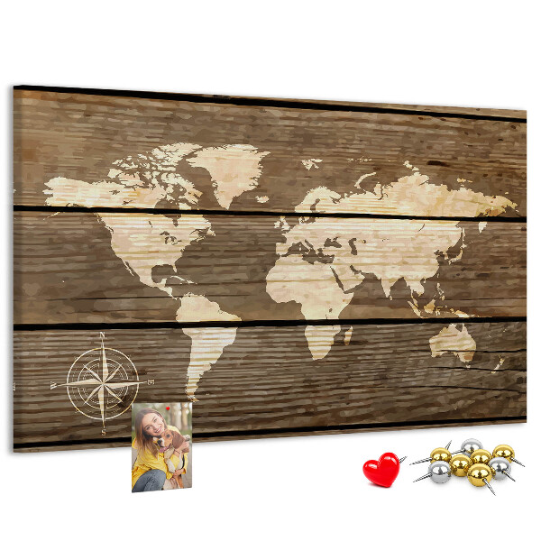 Tableau en liège Une carte du monde sur un fond de planches de bois