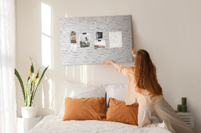 Tableau de liège Mur de briques blanches orné de punaises colorées