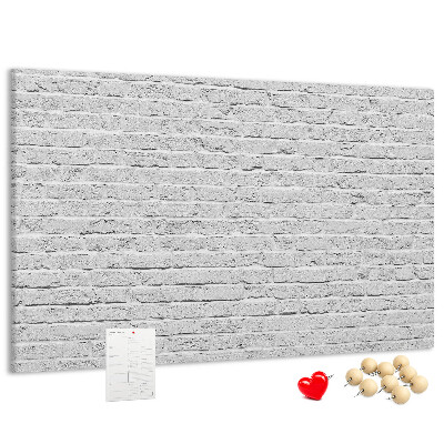 Tableau de liège Mur de briques blanches orné de punaises colorées